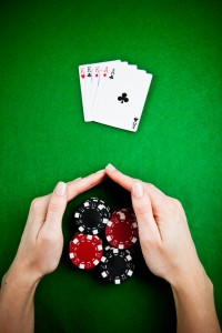 Female hands rakes up stack of gambling chips