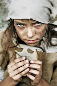 A portrait of a poor beggar child with a piece of bread in her hands. Please check for more.